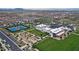 An aerial view showcasing the community amenities including a pool, tennis courts, and manicured landscaping at 9728 E Twinkle Ave, Mesa, AZ 85212