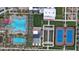Aerial view of community resort style pool, barbecue, common area, tennis court, bocce ball, and palm trees at 9728 E Twinkle Ave, Mesa, AZ 85212