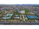 Aerial view of neighborhood featuring resort-style pool, tennis courts, playgrounds, and community green spaces at 9728 E Twinkle Ave, Mesa, AZ 85212