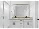 Modern bathroom features a double vanity, large mirror, and sleek glass shower enclosure at 9728 E Twinkle Ave, Mesa, AZ 85212