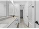 Modern bathroom showcasing double sinks, stone countertops, gray framed mirrors, and a separate shower at 9728 E Twinkle Ave, Mesa, AZ 85212