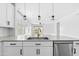 Bright kitchen featuring stainless steel sink and appliances, quartz countertops, and backyard views at 9728 E Twinkle Ave, Mesa, AZ 85212