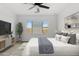 Bright main bedroom with a neutral color palette, a large window, ceiling fan, and a modern, inviting aesthetic at 9728 E Twinkle Ave, Mesa, AZ 85212