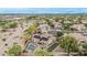Expansive aerial view of a desert home showcasing a pool, putting green, solar panels, and neighborhood surroundings at 11511 E Chestnut Ct, Chandler, AZ 85249