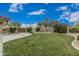 Spacious backyard with green lawn, desert landscaping, privacy fence, and lush greenery at 11511 E Chestnut Ct, Chandler, AZ 85249