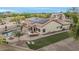 A serene backyard featuring a pool, patio with bbq, a putting green, and solar panels on the roof at 11511 E Chestnut Ct, Chandler, AZ 85249