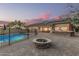 Expansive backyard features a pool, fire pit, and outdoor kitchen, ideal for entertaining guests or relaxing at 11511 E Chestnut Ct, Chandler, AZ 85249