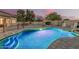 Fenced backyard features a pool, outdoor kitchen, and fire pit, creating an entertainer's paradise at 11511 E Chestnut Ct, Chandler, AZ 85249