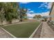 A perfectly manicured faux grass area with mature landscaping is perfect for outdoor entertaining at 11511 E Chestnut Ct, Chandler, AZ 85249
