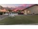 Lush backyard featuring a pool, built in grill, and ample seating for relaxing in the shade at 11511 E Chestnut Ct, Chandler, AZ 85249