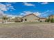 Expansive backyard featuring a built-in fire pit, faux grass, mature trees and rock landscaping at 11511 E Chestnut Ct, Chandler, AZ 85249