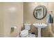 Neutral powder bathroom with white fixtures, vanity, decorative mirror, and a tiled floor at 11511 E Chestnut Ct, Chandler, AZ 85249