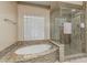 Luxurious bath featuring a soaking tub, a glass enclosed shower, and mosaic tile accents at 11511 E Chestnut Ct, Chandler, AZ 85249