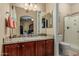 Bathroom features a granite counter with cherry cabinets, a large mirror, and a walk-in shower at 11511 E Chestnut Ct, Chandler, AZ 85249