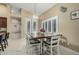 Cozy breakfast nook with a wooden table, white chairs, and bright natural light at 11511 E Chestnut Ct, Chandler, AZ 85249