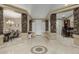 Inviting entryway featuring stone pillars, a decorative tile mosaic and views into the dining and living spaces at 11511 E Chestnut Ct, Chandler, AZ 85249