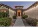 Inviting entryway with a decorative front door, desert landscaping, and pathway lighting at 11511 E Chestnut Ct, Chandler, AZ 85249