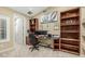 Functional home office with custom wood shelving, built-in desk, and cozy carpet at 11511 E Chestnut Ct, Chandler, AZ 85249