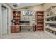 Bright home office with custom wood shelving, built-in desk, and comfortable carpet at 11511 E Chestnut Ct, Chandler, AZ 85249