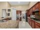 Spacious kitchen features granite countertops, stainless steel appliances, and dark wood cabinetry at 11511 E Chestnut Ct, Chandler, AZ 85249