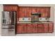 This kitchen features stainless steel appliances, granite countertops, and beautiful wood cabinets at 11511 E Chestnut Ct, Chandler, AZ 85249
