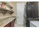 Convenient laundry room equipped with stacked washer/dryer and plenty of storage space at 11511 E Chestnut Ct, Chandler, AZ 85249