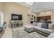 Inviting living room with a sectional sofa, a large television, and neutral decor at 11511 E Chestnut Ct, Chandler, AZ 85249