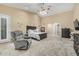 Bright bedroom with neutral walls, large windows, carpet flooring, and ceiling fan at 11511 E Chestnut Ct, Chandler, AZ 85249