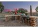 Outdoor kitchen boasts a built-in grill and beverage center, ideal for backyard barbecues and hosting guests at 11511 E Chestnut Ct, Chandler, AZ 85249