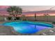Sparkling swimming pool with rock waterfall feature, perfect for cooling off on hot summer days and creating a backyard oasis at 11511 E Chestnut Ct, Chandler, AZ 85249
