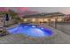 Resort-style pool and spa with lush landscaping, perfect for relaxing and enjoying the outdoors in style at 11511 E Chestnut Ct, Chandler, AZ 85249