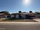 Charming single-story home with a well-manicured front yard and a covered carport at 12231 N 22Nd Ave, Phoenix, AZ 85029