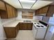 Small kitchen area with linoleum flooring, tile countertops, and plywood replacing the window at 12231 N 22Nd Ave, Phoenix, AZ 85029