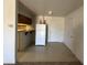 Compact kitchen with essential appliances, tile flooring, and simple cabinetry at 12231 N 22Nd Ave, Phoenix, AZ 85029
