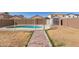 Fenced backyard with a pool, shed, and an access path at 12430 W Scotts Dr, El Mirage, AZ 85335