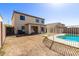 Spacious fenced backyard featuring a lawn and patio, with a view of the two-story home at 12430 W Scotts Dr, El Mirage, AZ 85335