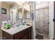 Bathroom featuring a vanity with sink, mirror, and a shower with colorful curtains at 12430 W Scotts Dr, El Mirage, AZ 85335
