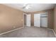 Bedroom featuring neutral carpet, closet, and doorways with ample space at 12430 W Scotts Dr, El Mirage, AZ 85335