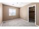 Bedroom featuring neutral carpet, a window with blinds, and a walk-in closet at 12430 W Scotts Dr, El Mirage, AZ 85335