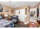 Cozy bedroom with wood floors, a recliner, and unique decorative items at 12430 W Scotts Dr, El Mirage, AZ 85335