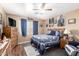Comfortable bedroom showcasing a bed, wood floors, TV, and Dallas Cowboys decor at 12430 W Scotts Dr, El Mirage, AZ 85335