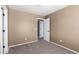 Bedroom showcasing neutral carpet, a window, and an open doorway at 12430 W Scotts Dr, El Mirage, AZ 85335