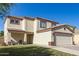 Charming two-story home featuring a well-maintained lawn and two-car garage at 12430 W Scotts Dr, El Mirage, AZ 85335