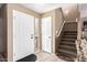 Inviting foyer featuring tile flooring, staircase, and front door with sidelight at 12430 W Scotts Dr, El Mirage, AZ 85335
