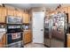Kitchen with wood cabinets, stainless steel appliances, and tile flooring at 12430 W Scotts Dr, El Mirage, AZ 85335