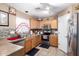 Well-lit kitchen with stainless steel appliances and tile backsplash at 12430 W Scotts Dr, El Mirage, AZ 85335