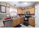 Bright kitchen featuring stainless steel appliances and mosaic tile backsplash at 12430 W Scotts Dr, El Mirage, AZ 85335