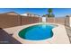 Features a refreshing in-ground pool with clear blue water, set within a fenced backyard at 12430 W Scotts Dr, El Mirage, AZ 85335