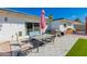 Inviting back patio with stone pavers, outdoor seating, string lights and pink umbrella at 14616 N 28Th Pl, Phoenix, AZ 85032