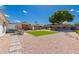 Expansive backyard with lush turf, patio seating, pergola, mature trees, and gravel landscape at 14616 N 28Th Pl, Phoenix, AZ 85032